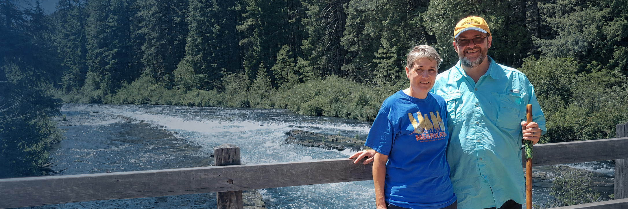 Daniel and Phyllis beside a forest river